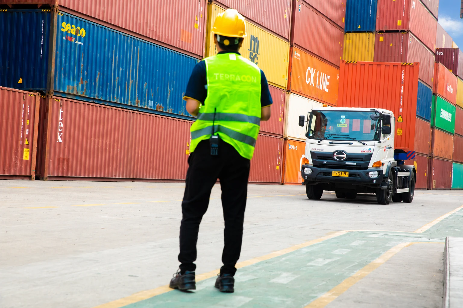 Yard officer monitoring an arriving container truck